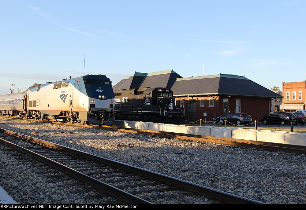 The northbound Saluki passes IC 8701 at the old Carbondale passenger station